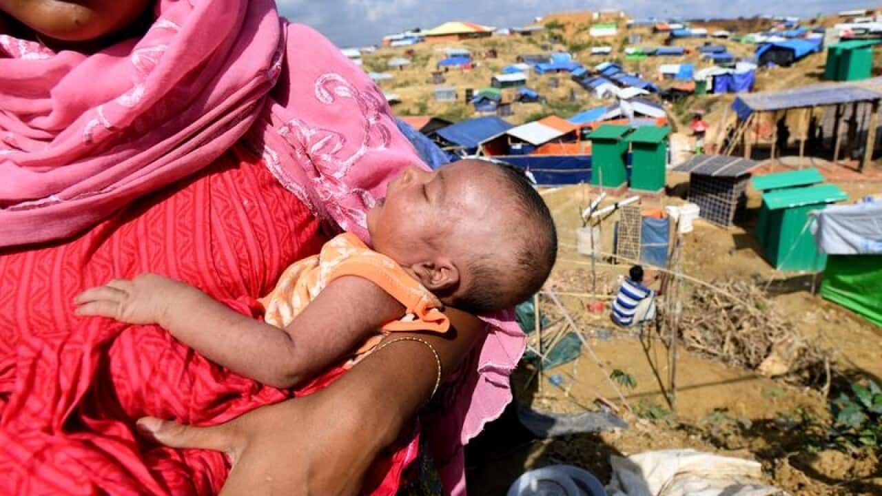 File image of a Rohingya refugee with her baby at a refugee camp.