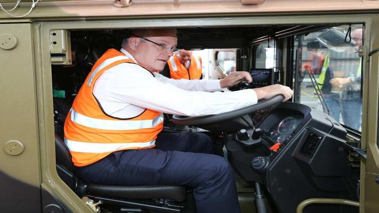 Scott Morrison sits in a defence company truck in Queensland.