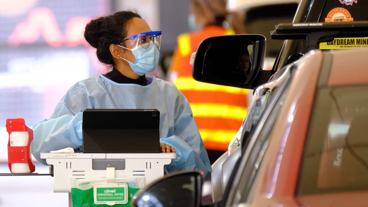 Health workers are seen testing people for Covid19 at Royal Melbourne Showgrounds in Melbourne.