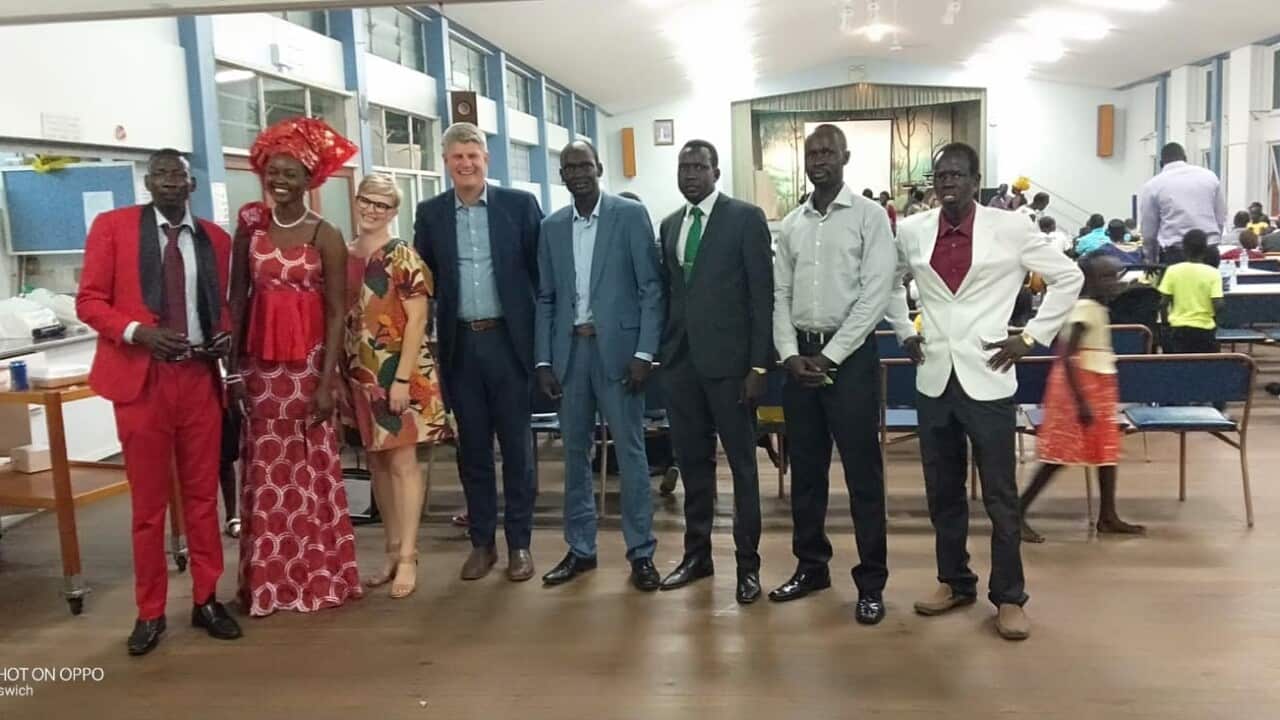 Minister SJ Hinchliff with members of the Dinka Bor Community