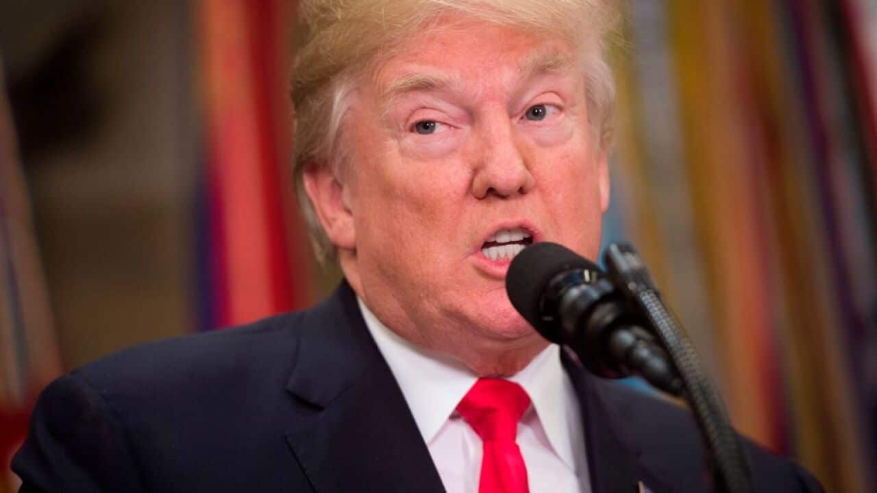 US President Donald Trump speaks at podium