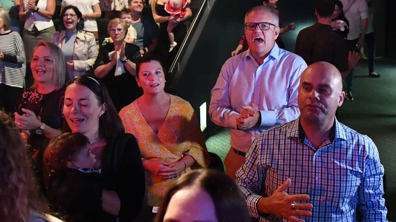 Prime Minister Scott Morrison and wife Jenny sing during an Easter Sunday service at his Horizon Church at Sutherland in Sydney.