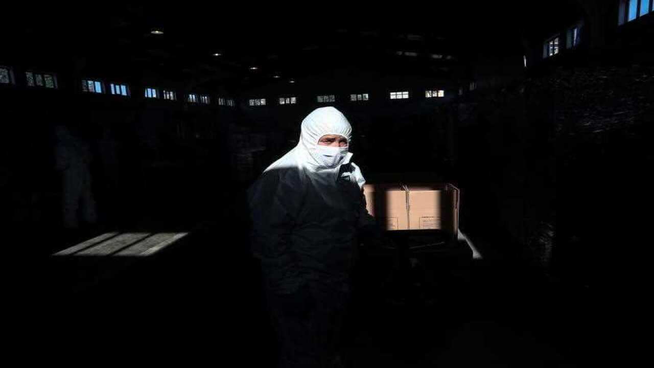 A man wearing a protective suit prepares Ramadan Food packages to be distributed to households in Istanbul, Turkey, 24 April