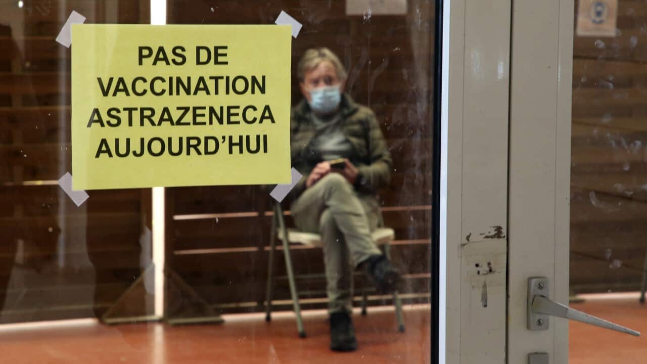 A man waits in a vaccination center where a sign reads "No AstraZeneca vaccinations today" in Saint-Jean-de-Luz, southwestern France on 16 March 2021.