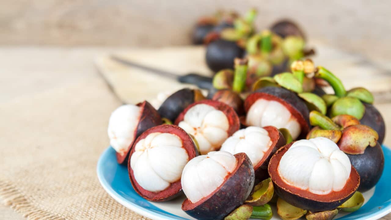 Mangosteen on wood table.