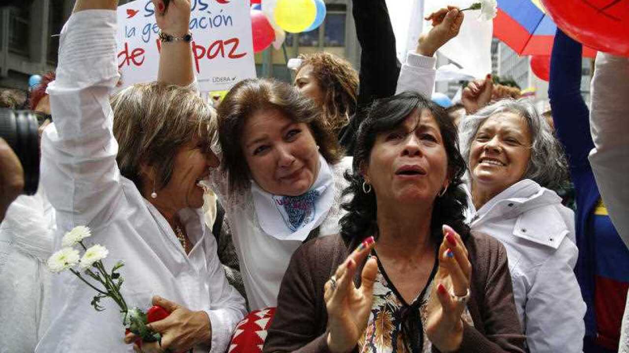 People celebrate the agreement between Revolutionary Armed Forces of Colombia, FARC, and Colombia's government, in Bogota, Colombia, Thursday, June 23, 2016.