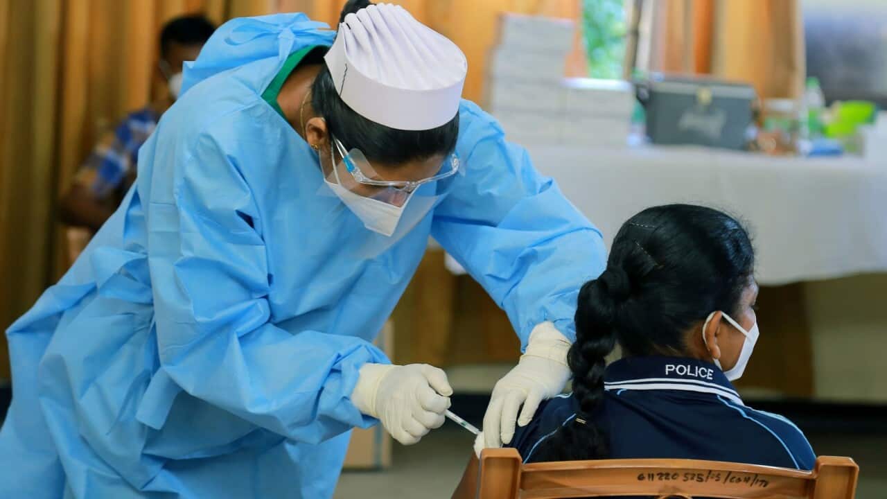 A police officer gets a COVID-19 vaccination in Colombo, Sri Lanka