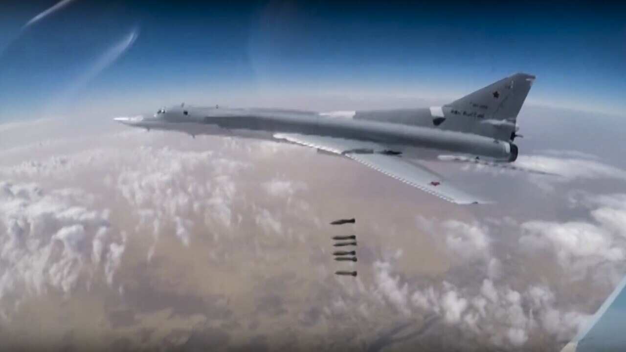In this photo made from the footage taken from Russian Defense Ministry official web site on Friday, Nov. 3, 2017, a Russian Tu-22M bomber unloads bombs on IS targets near Abu-Kemal, Syria.