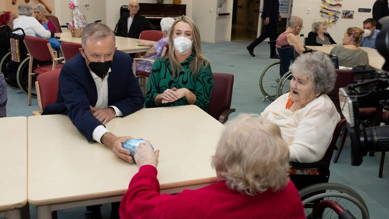 Anthony Albanese and partner Jodie Haydon hand out chocolate Easter eggs to residents during a visit to Fairways Retirement Living and Residential Aged Care in Bundaberg