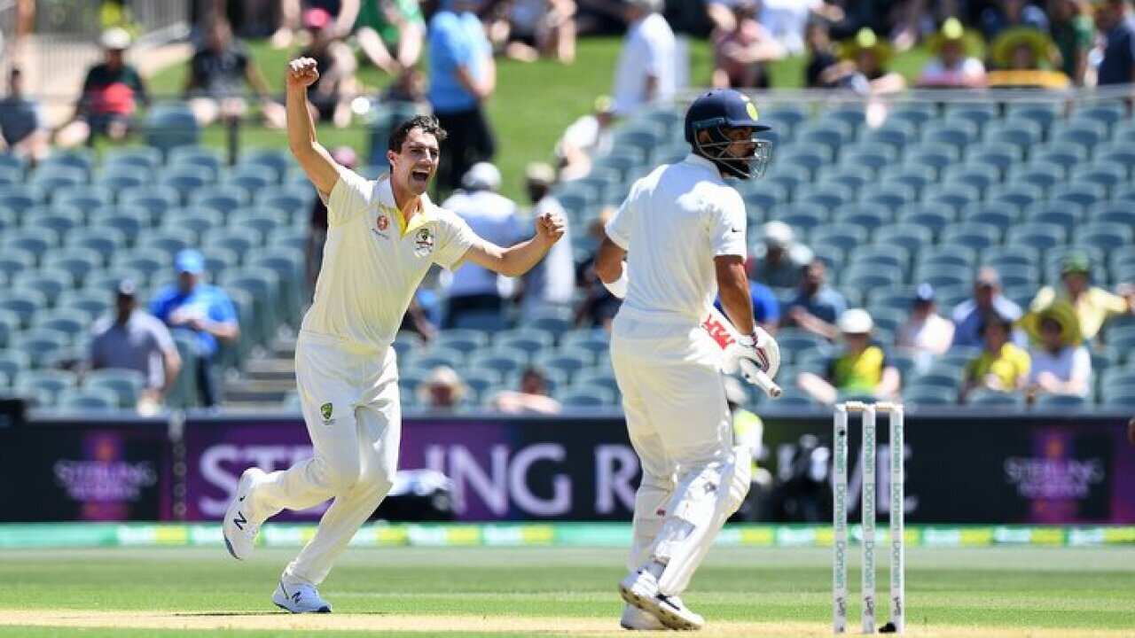 Australian bowler Pat Cummins reacts after dismissing Indian batsman Virat Kohli during day one of the first Test match between Australia and India in Adelaide.