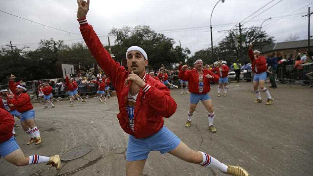 Members of the all-male dance group "The 610 Stompers" perform during the Krewe of Proteus Mardi Gras Parade in New Orleans, Monday, Feb. 16, 2015. The day is known as Lundi Gras, the day before Mardi Gras. (AP Photo/Gerald Herbert)