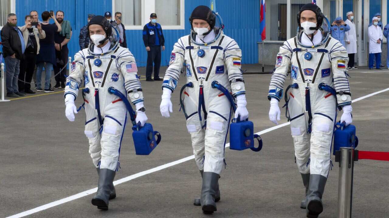 US astronaut Mark Vande Hei and Russian cosmonauts Oleg Novitsky and Pyotr Dubrov, walk prior to the launch at the Baikonur cosmodrome.