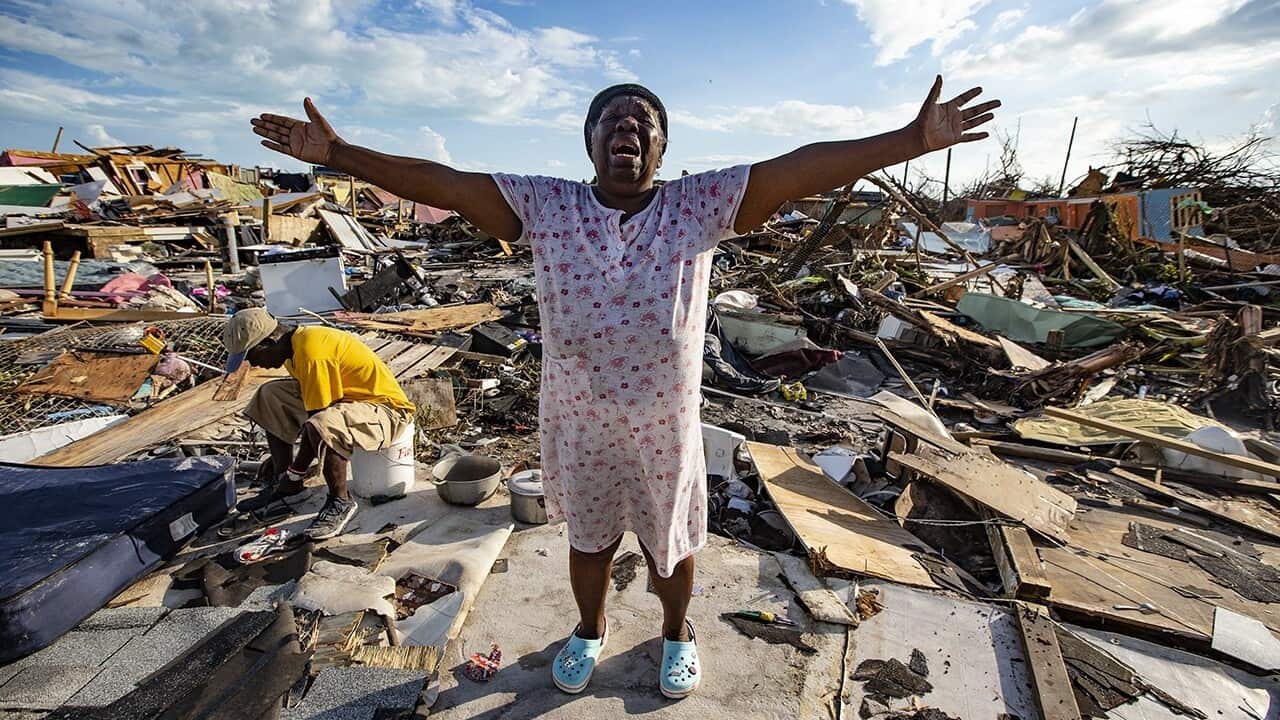 Aliana Alexis of Haiti stands on the concrete slab of what is left of her home after destruction from Hurricane Dorian in Great Abaco Island, Bahamas.