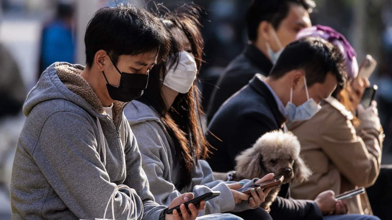 People wearing a mask in Shanghai on 23 March 2022.
