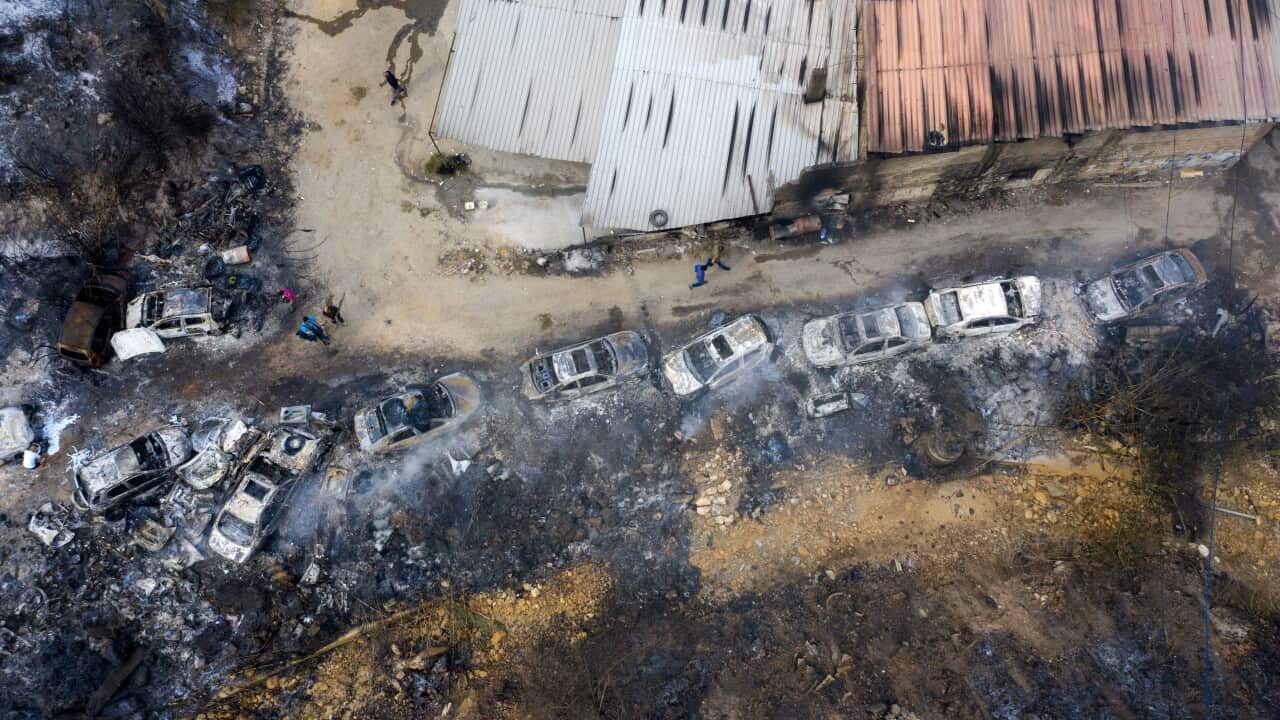 A picture taken with a drone shows an aerial view a row of burnt-out cars at Al Damour area south Beirut
