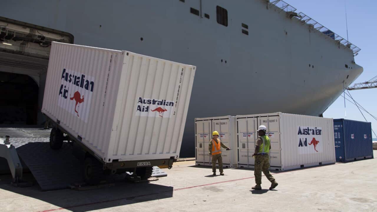 HMAS Canberra embarks Australian Aid stores on Operation Fiji Assist