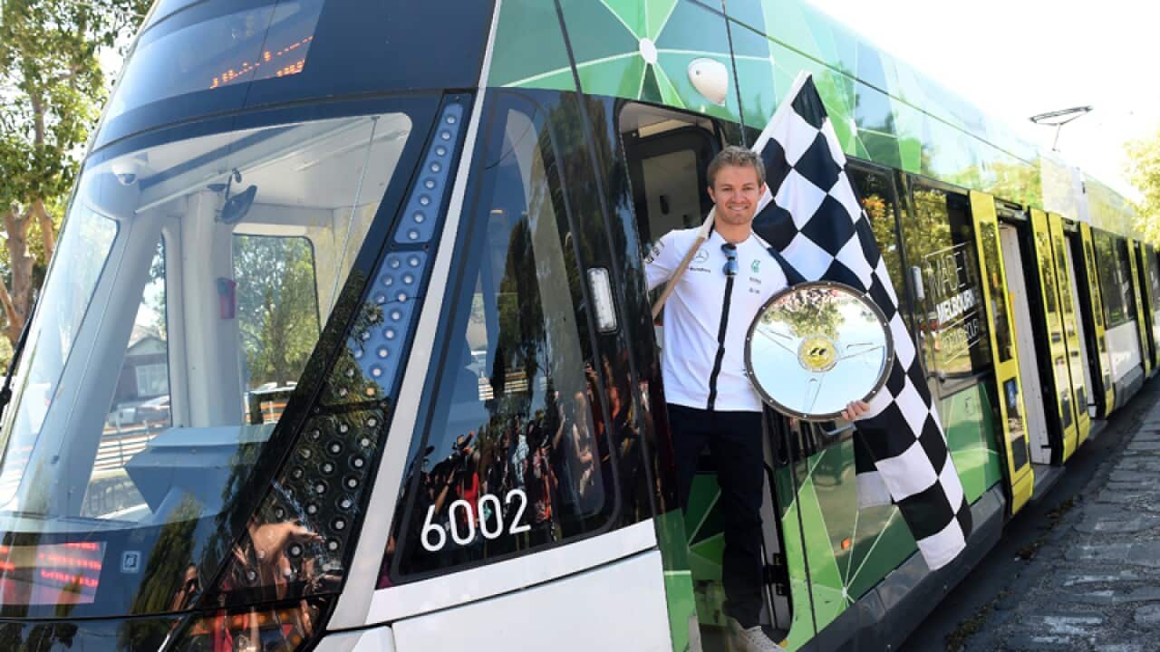 Formula One driver Nico Rosberg on board a Melbourne tram