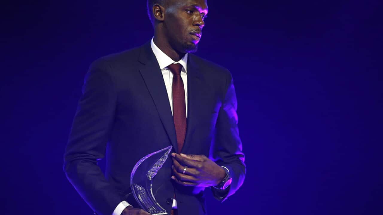 Usain Bolt with his trophy for the male World Athletes of the Year