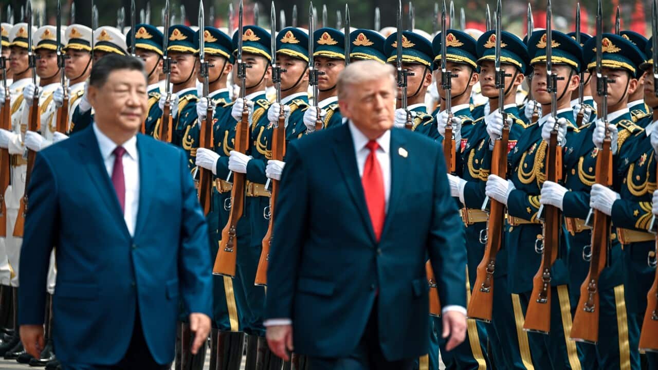 President Donald Trump reviews troops at the Great Hall of the People.
