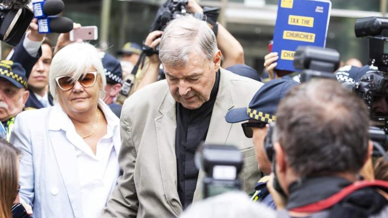Cardinal George Pell (Centre) is seen in Melbourne, Australia,