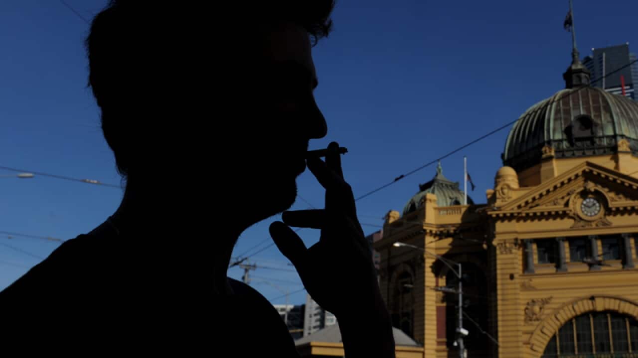 A man smokes a cigarette.