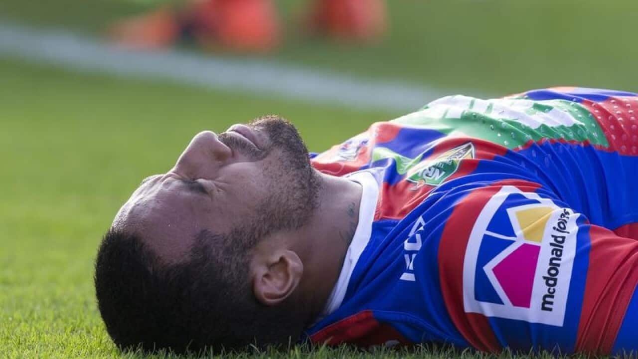 Tautau Moga of the Knights is injured after scoring