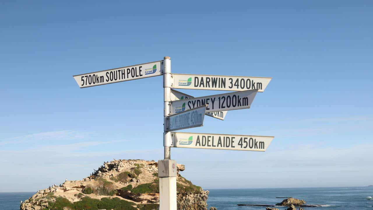 A signpost near Port Macdonnell with directions to major Australian cities and landmarks.