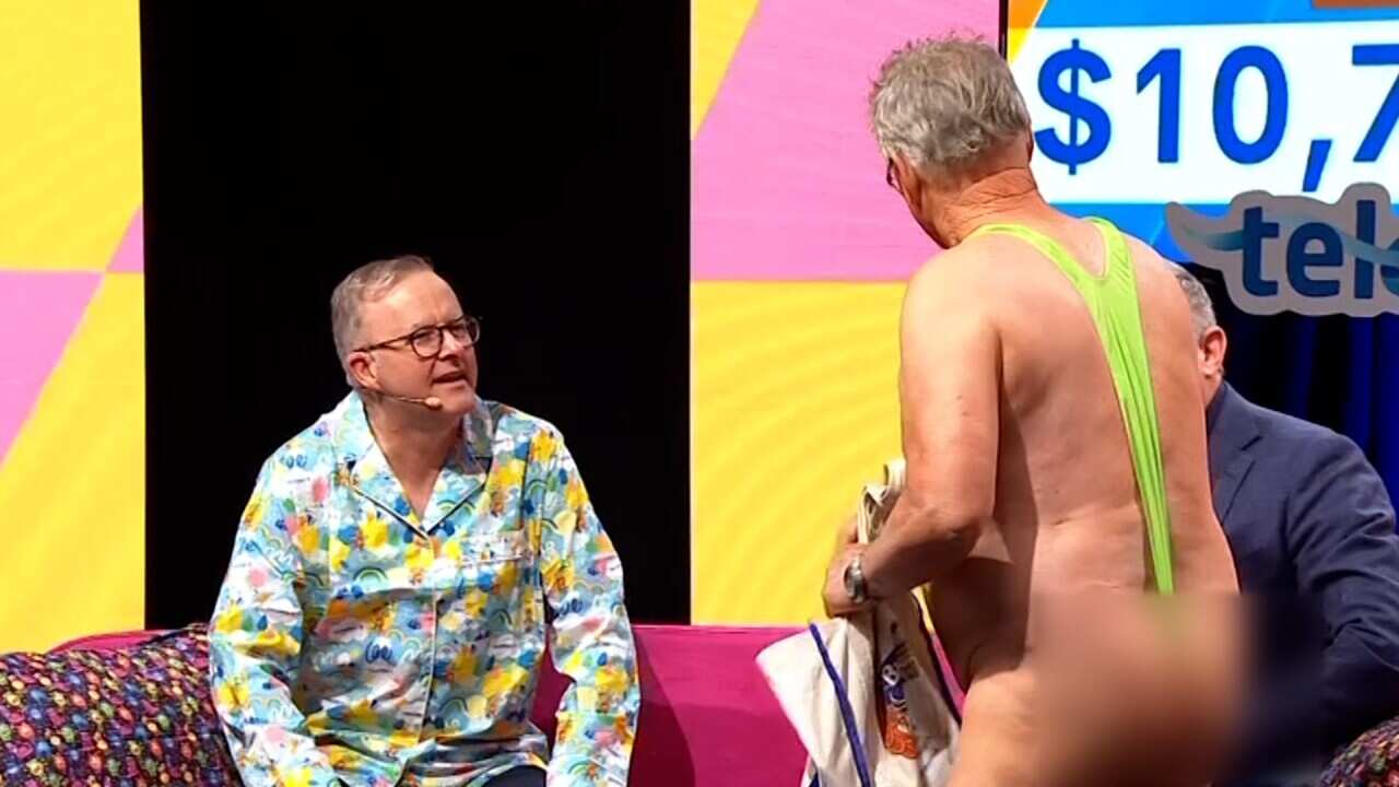 A man wearing a green mankini