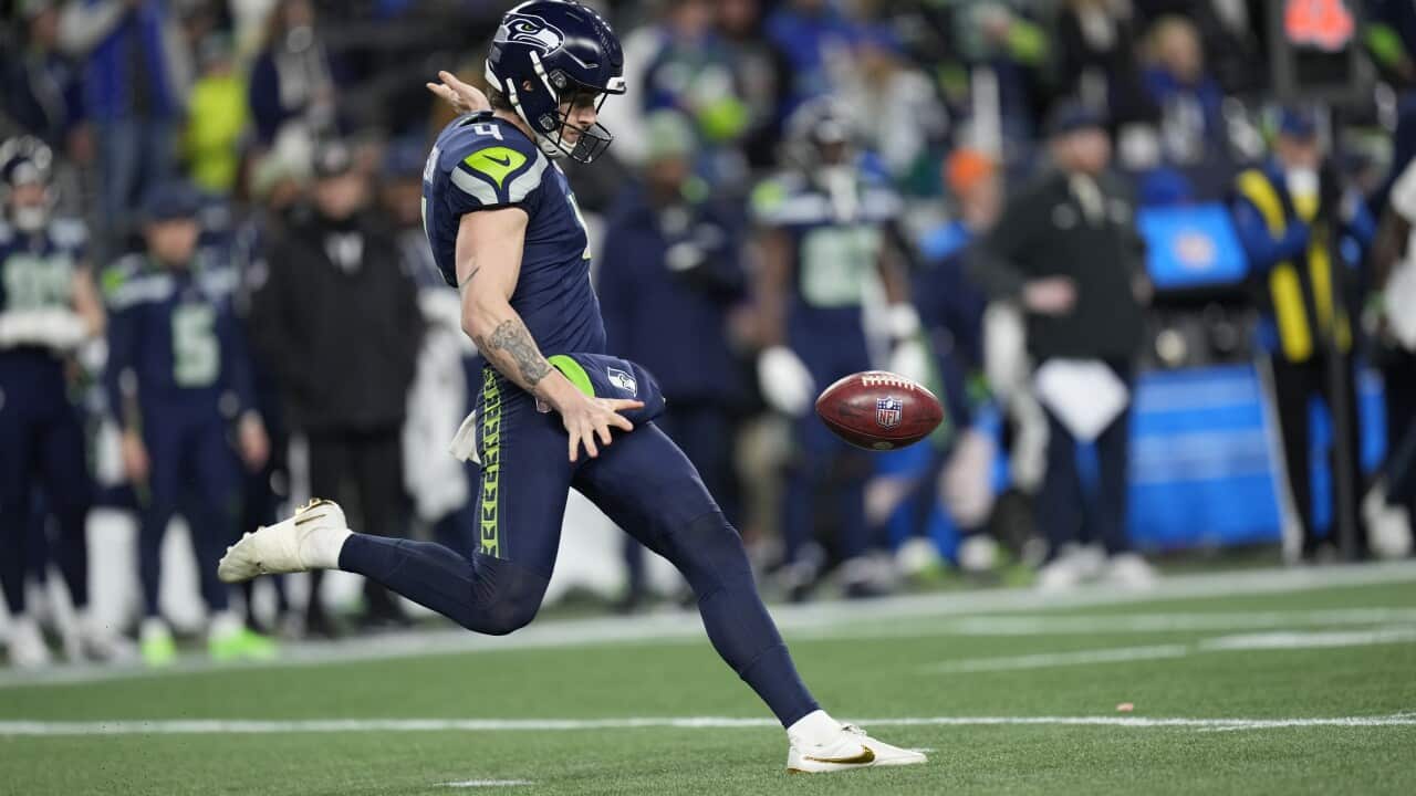 49ers Seahawks Football player wears uniform and is in the middle of kicking the ball