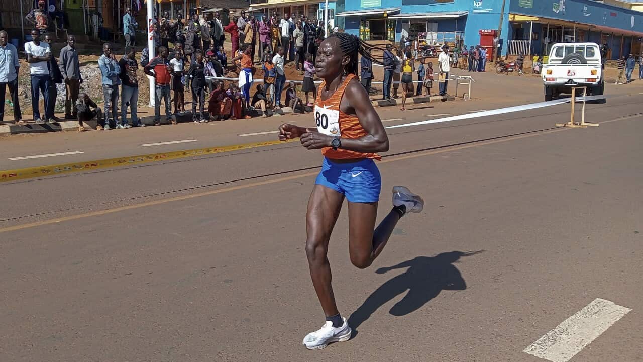 A woman in a singlet and shorts runnning