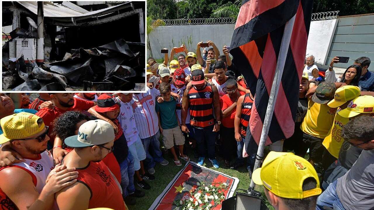 Brazilian football club Flamengo fans gather to lay flowers at the entrance of the club's training center