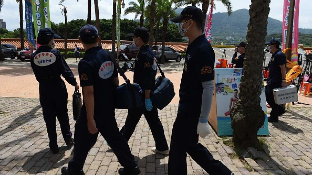 Local investigators arrive at the water park in Pali district, in New Taipei City