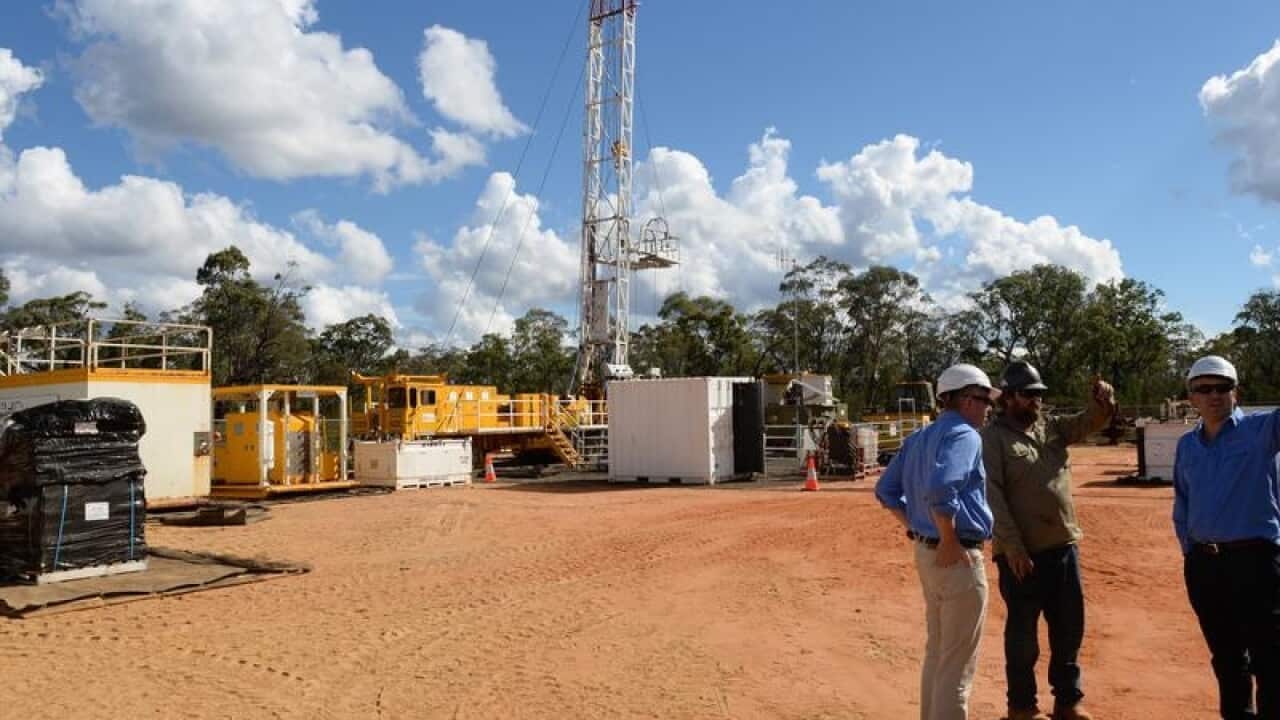 Santos staff at a coal seam gas (CSG) well rig.