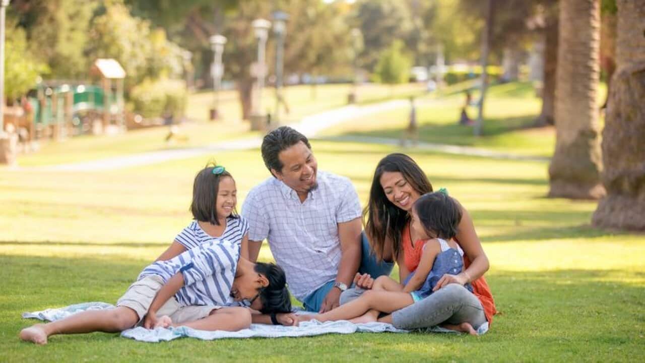 Filipino family relaxing outdoors