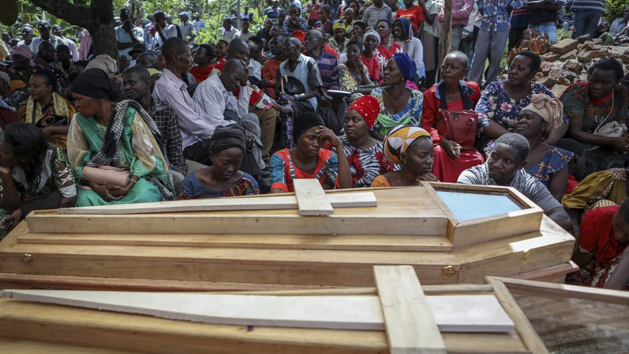 Relatives mourn Florence Masika and her son Zakayo Masereka, who were both killed in the attack on the Lhubiriha Secondary School