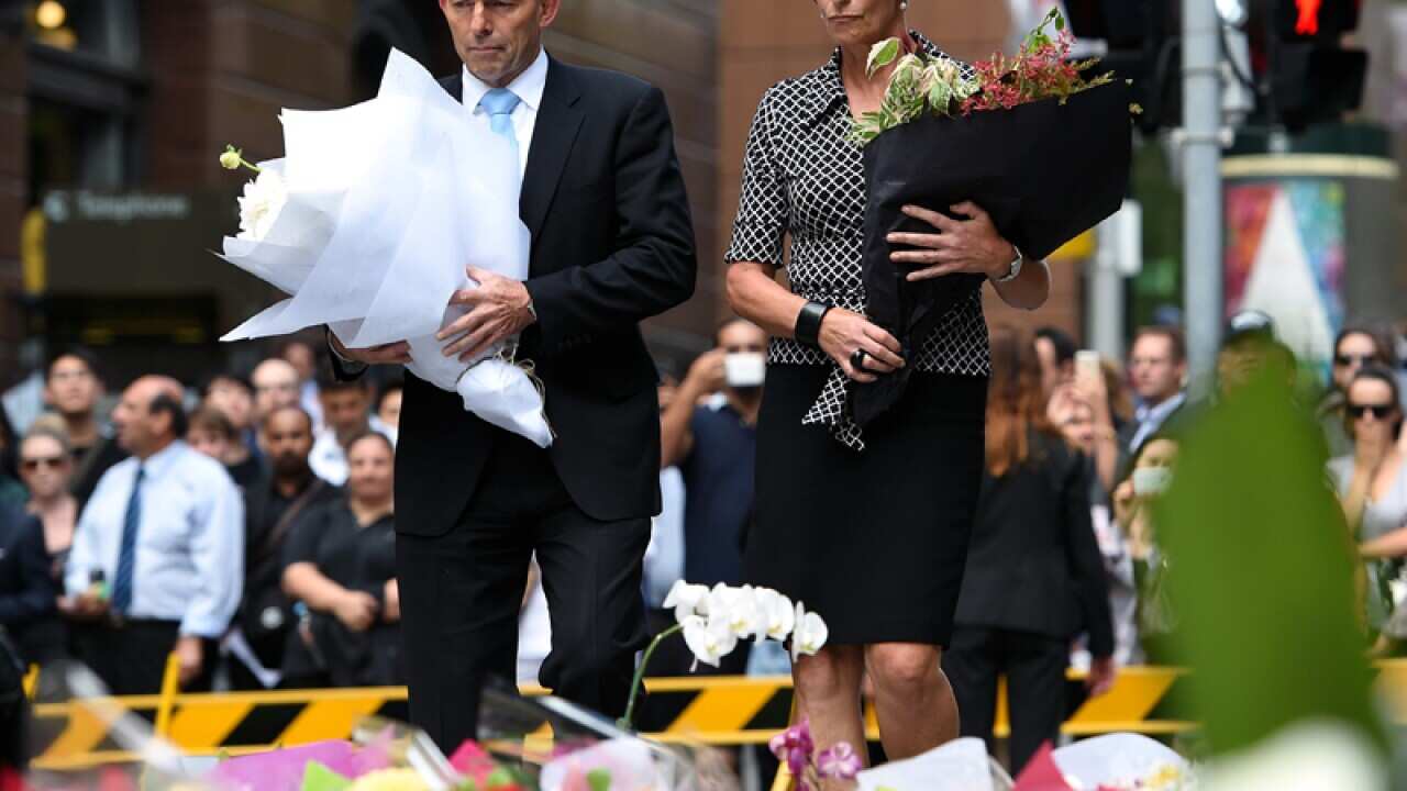 Tony Abbott and his wife Margie lay flowers in Martin Place