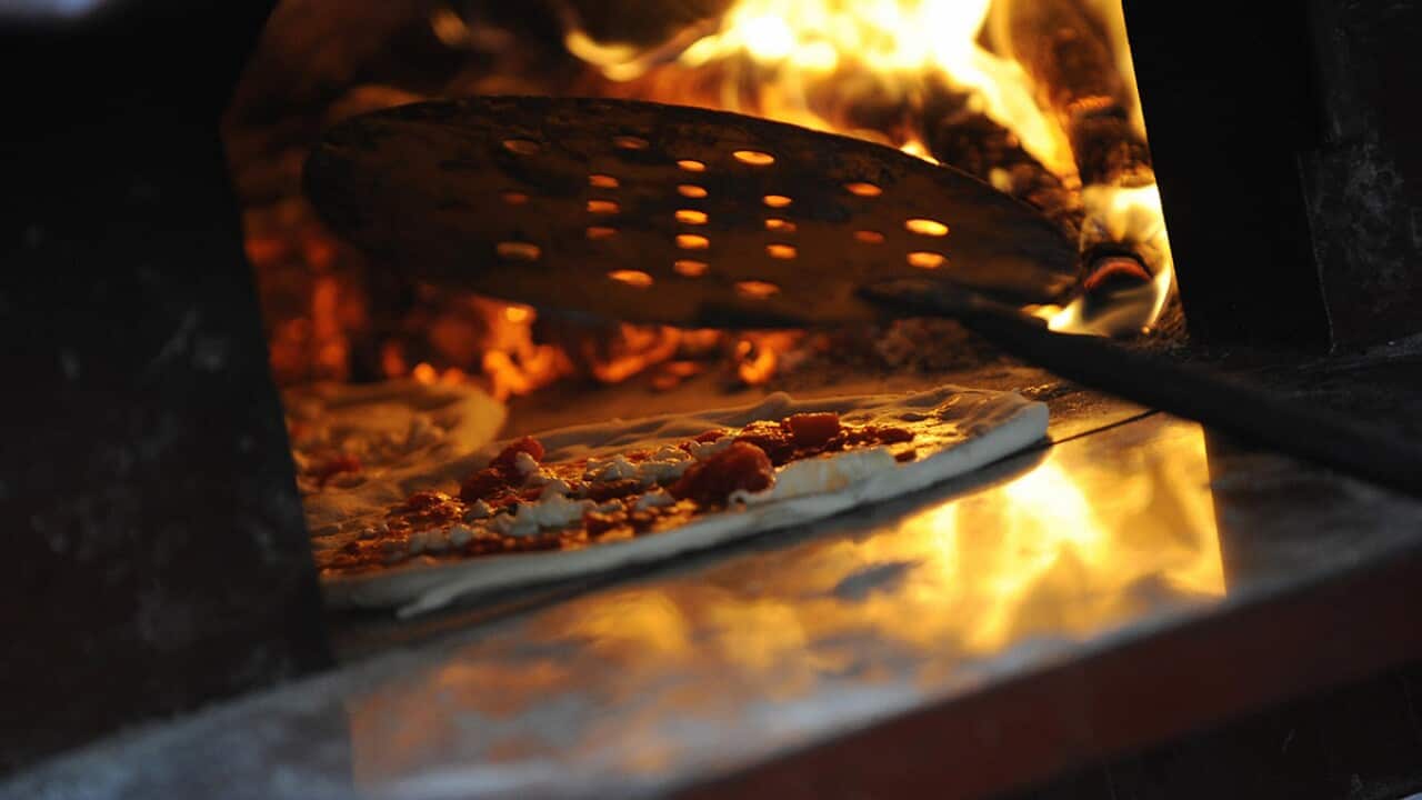 pizza baking in an oven in Naples
