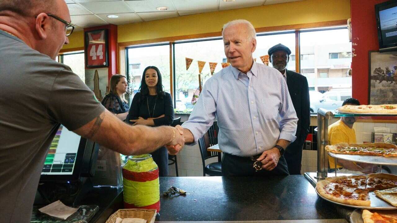 Democratic presidential candidate and former Vice President Joe Biden greets people at Gianni's Pizza