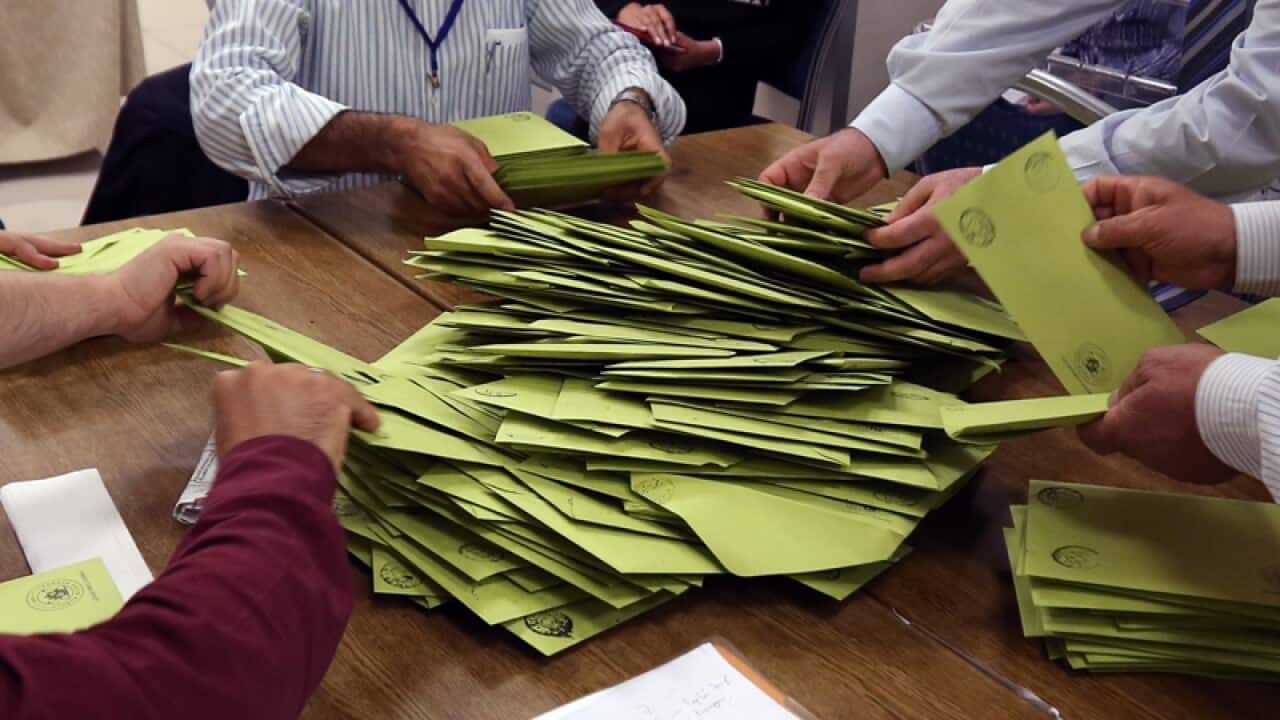 Polling station officials count ballots