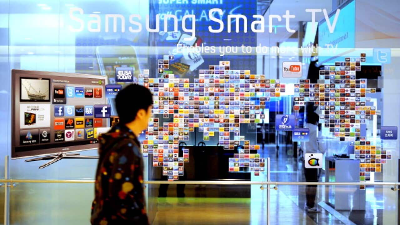 A South Korean man walks past a Samsung smart TV advertisement (PARK JI-HWAN/AFP/Getty Images)