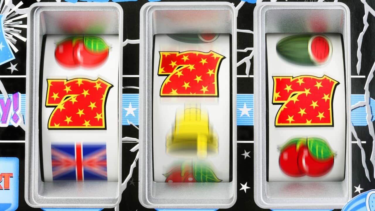 Fruit machine bars spinning to line of 7's, close-up (blurred motion)