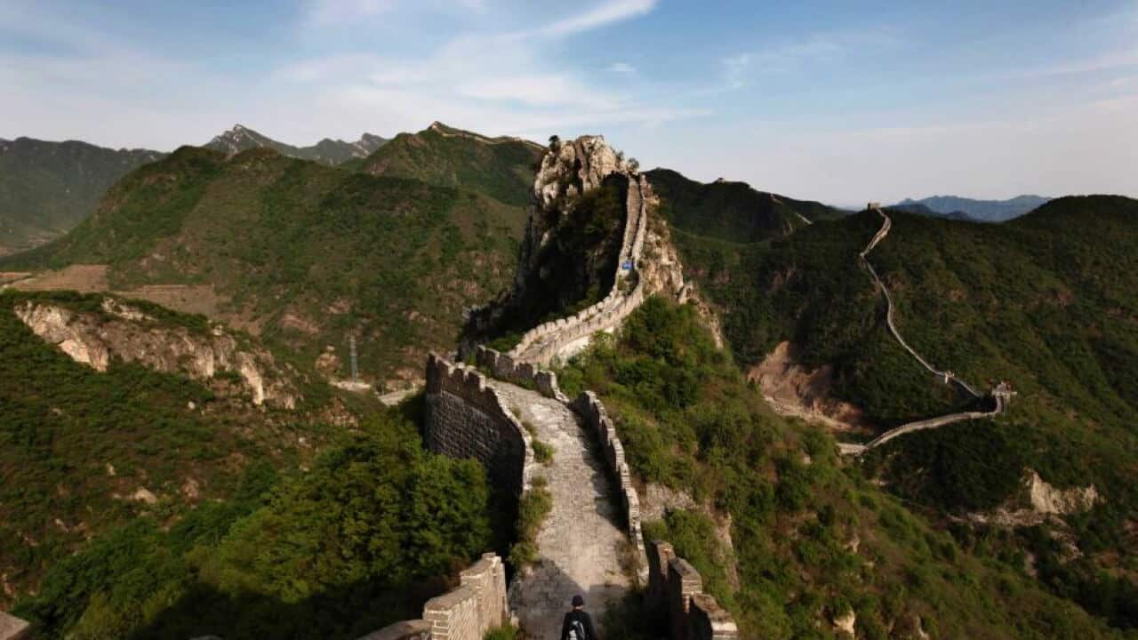 A visitor walks on the Luanling section of the Great Wall of China.