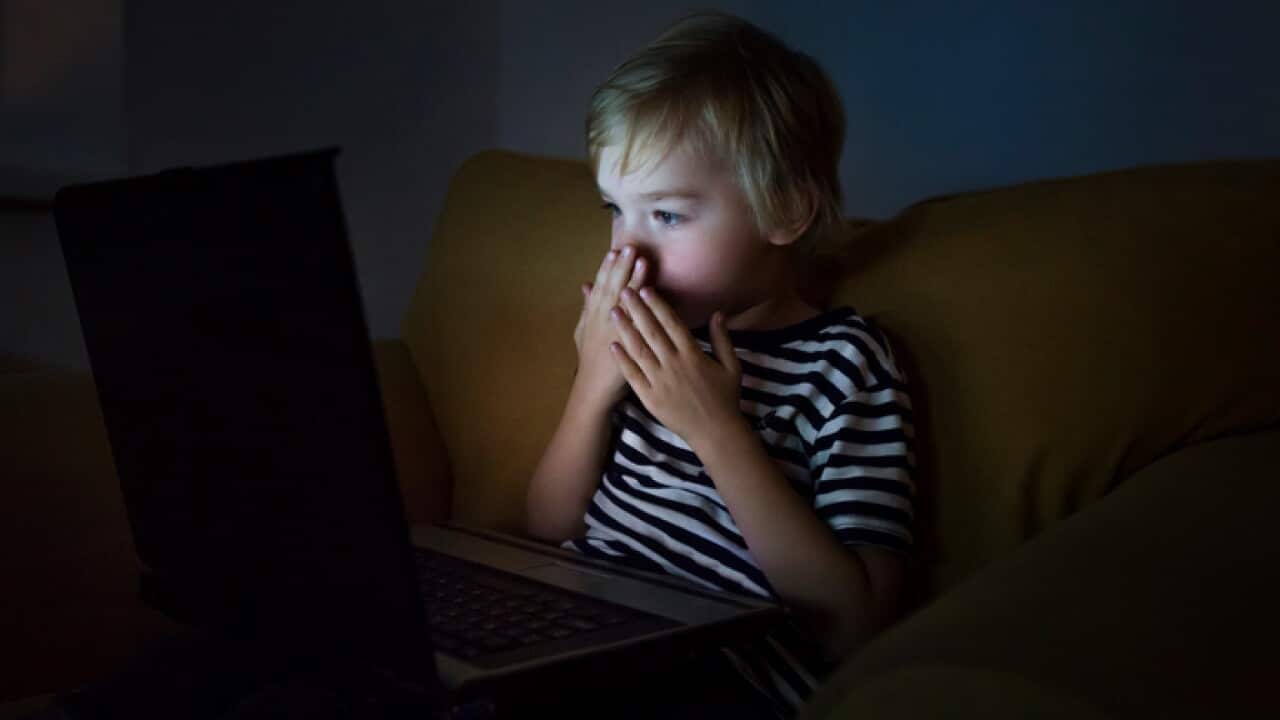 Scared boy in front of the laptop