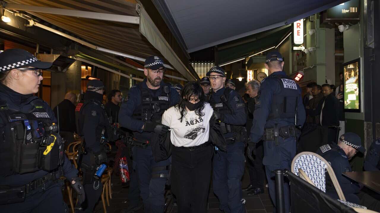 Police escort Anti-Israeli protesters outside an Israeli restaurant Miznon
