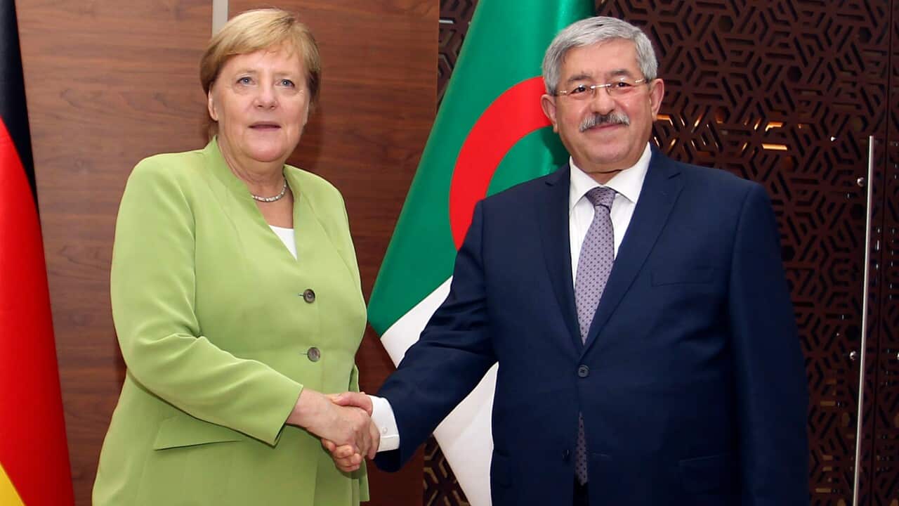 German Chancellor Angela Merkel shakes hands with Algerian Prime Minister Ahmed Ouyahia ahead of talks in Algiers, Monday Sept.17, 2018. Merkel is visiting Algeria for a day to promote bilateral ties and discuss migration and the situation in neighboring