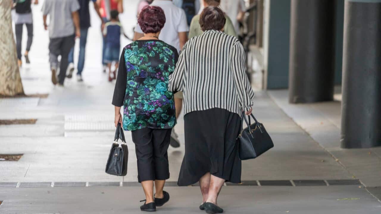 Elderly people walk in the street