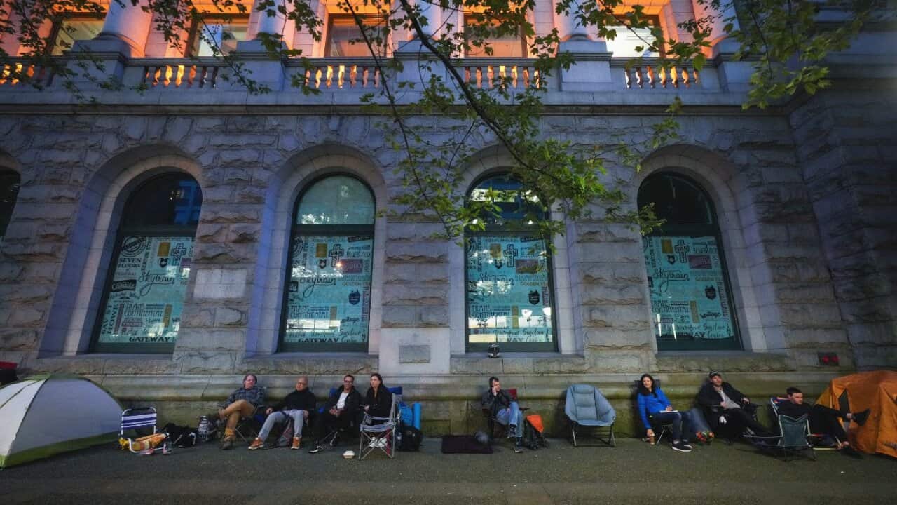 People camp overnight outside a Service Canada passport office, in Vancouver.