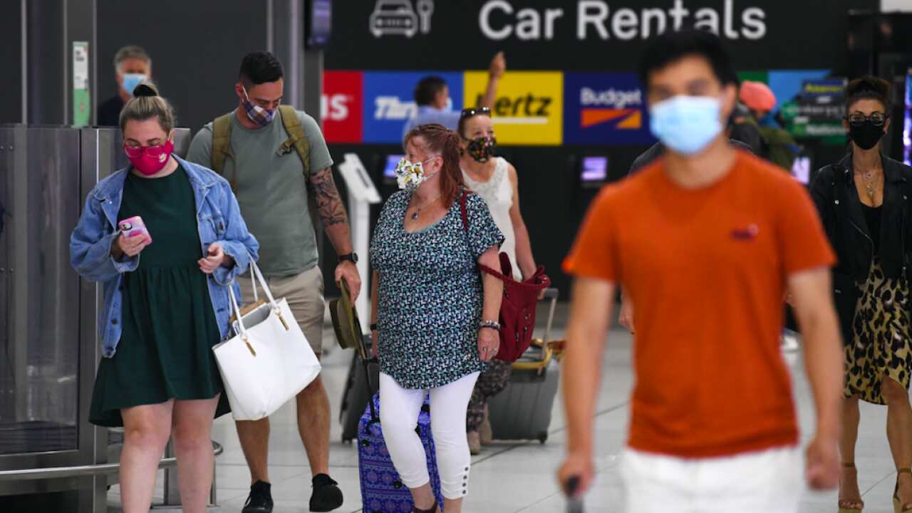People wearing face masks are seen at Tullamarine Airport in Melbourne, Friday, January 8, 2021