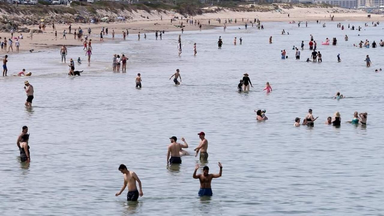 Beachgoers are seen at Henley Beach in Adelaide (file image)
