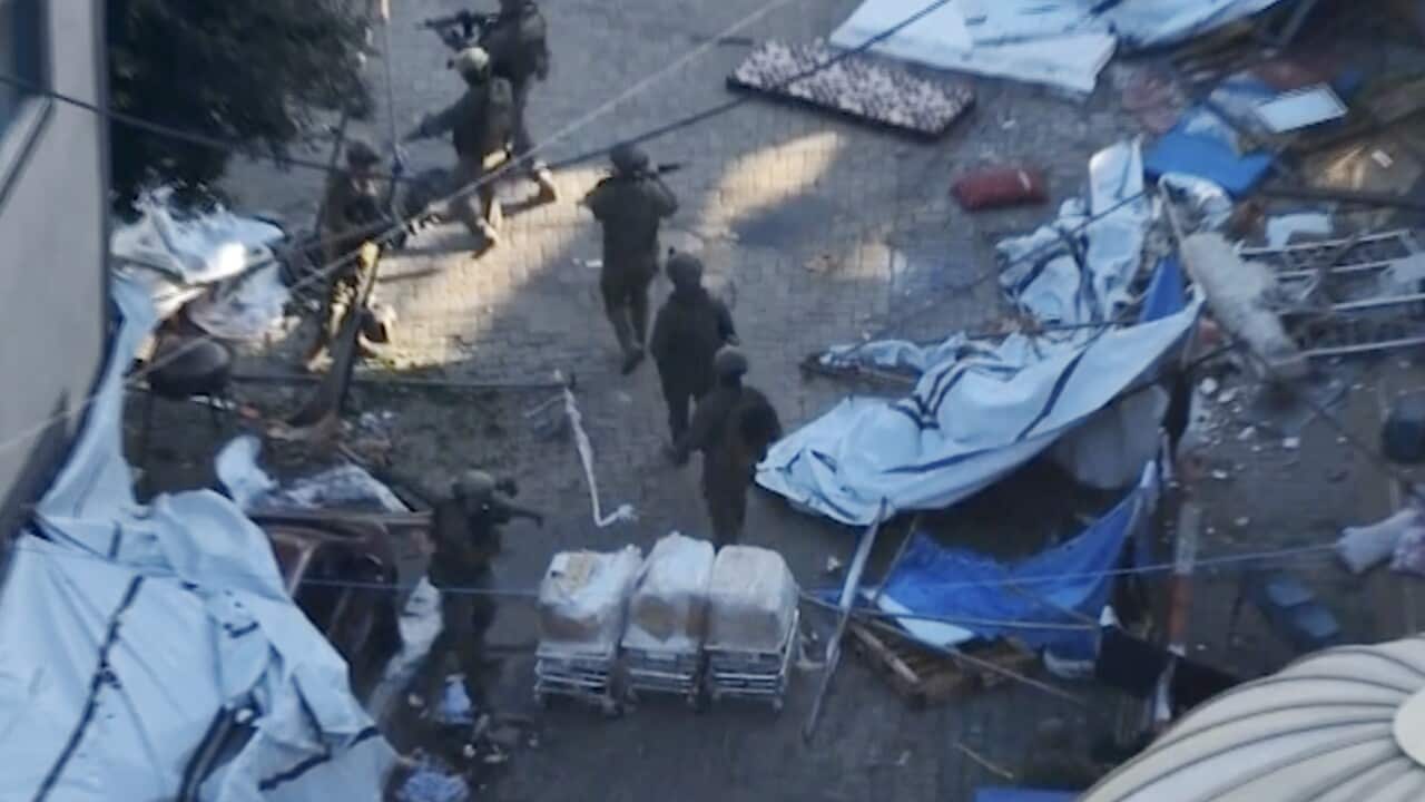 An aerial view of soldiers walking on a street.